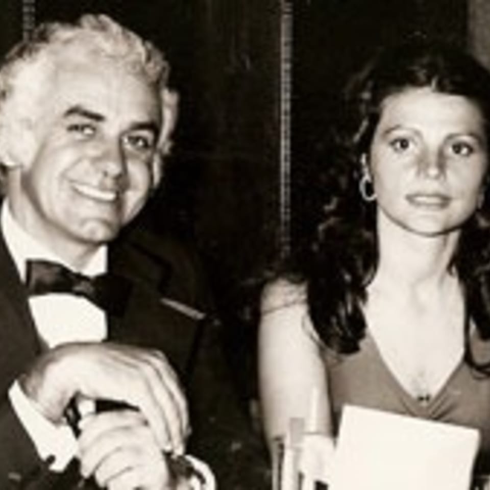 A smiling man in a tuxedo and a woman in a dress at The Bistro K.