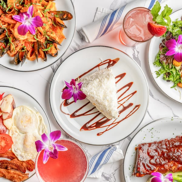 A flat lay of various Italian dishes including seafood pasta, ribs, salad, breakfast, and dessert.